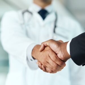 ASNC2025_Business_Track Closeup, doctor or man with handshake, negotiation or planning with partnership, healthcare or wellness. Medical professional, consultant or employee with an offer, support or teamwork with promotion