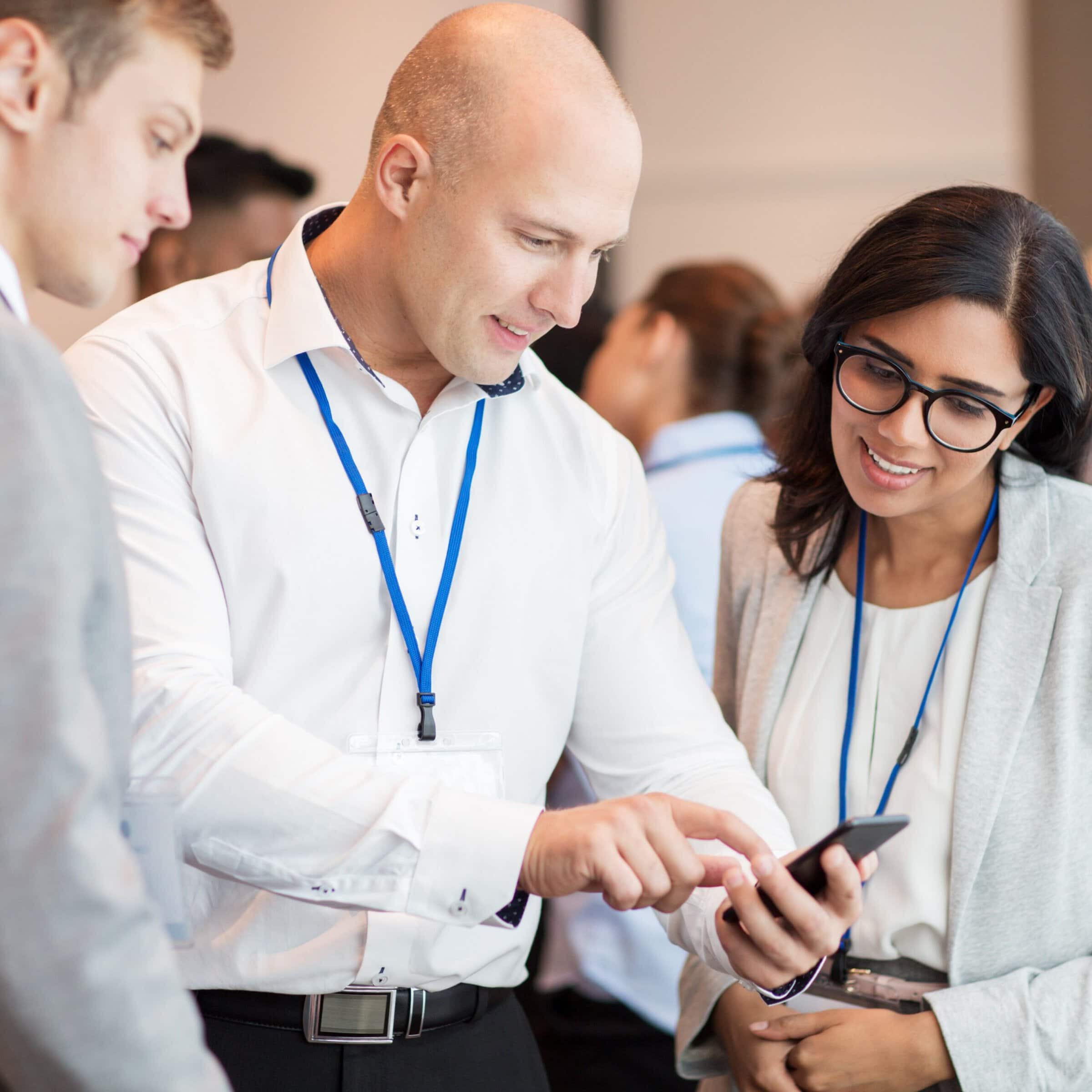 couple with smartphone at business conference